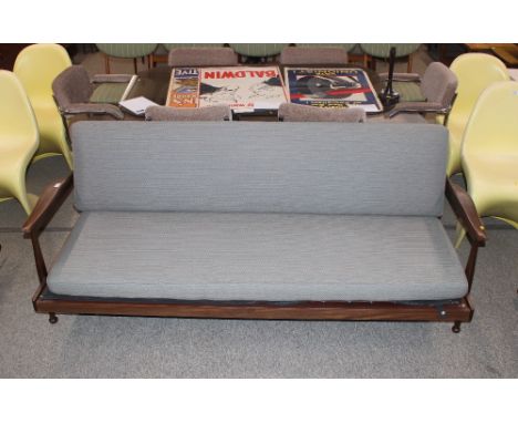 A 1960's teak sofa bed by Guy Rogers