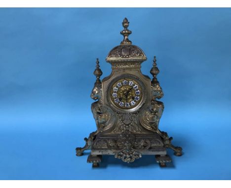 An ornate eight day metalwork clock