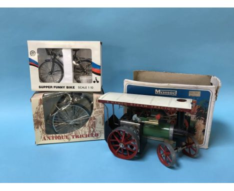 A boxed Mamod steam tractor and two boxed model bikes