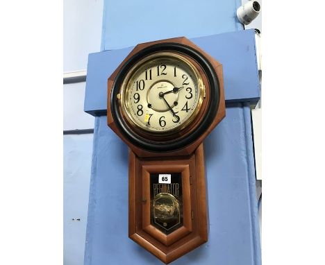 A walnut octagonal cased wall clock
