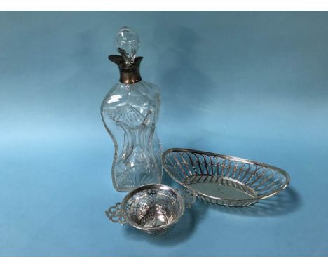 A silver rimmed cut glass dimple decanter and two silver baskets