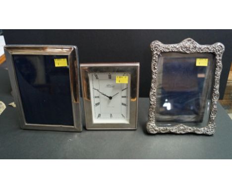 A silver mounted mantel clock, by R Carr, Sheffield, having battery movement; together with two silver photograph frames.