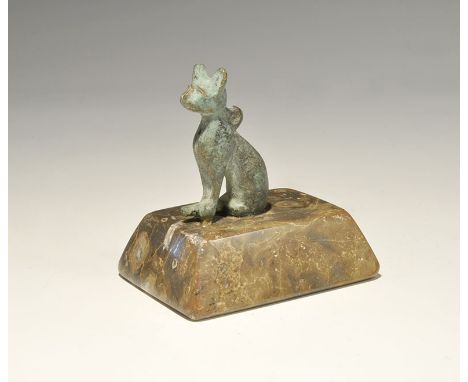 "20th century AD. A bronze pendant of the goddess Bastet with loop to the shoulders, mounted on an onyx stand. 429 grams, 87m