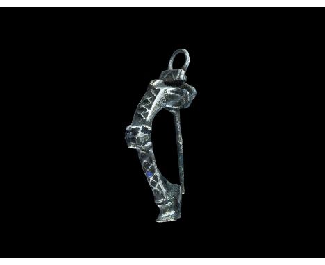 "1st-2nd century AD. A T-shaped bow brooch with sprung loop and plaque with raised chevron detail, thick bow and arms, with r