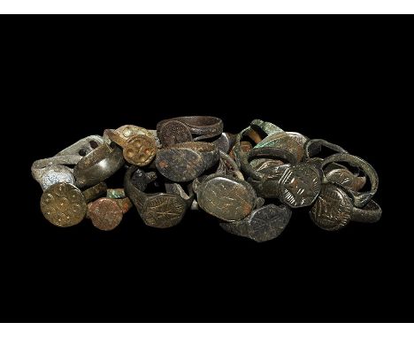 "1st-18th century AD. A mixed group of bronze finger rings comprising: one with elongated plaque, two glass inserts; one with