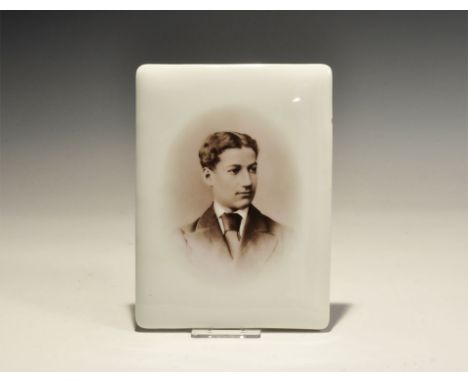 "20th century. A photograph of a young man fused to a white glass tile. 203 grams, 15cm (6 1/4"). Property of an Essex collec
