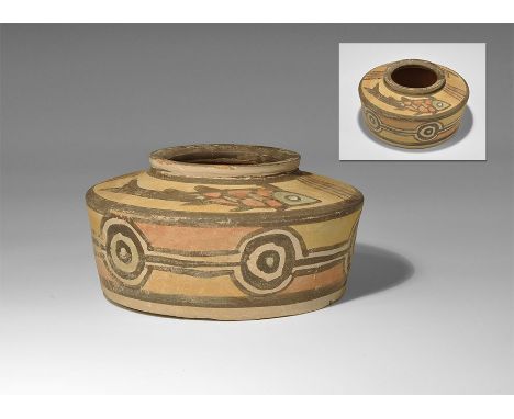 "3300-1700 BC. A squat terracotta jar with deep shoulder and raised rim, polychrome fish to the shoulder, band of concentric 