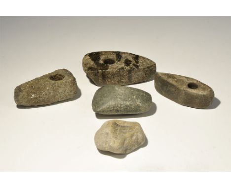"Neolithic, 5000-1500 BC. A mixed group comprising: three triangular form pecked and polished perforated axes; a small plain 