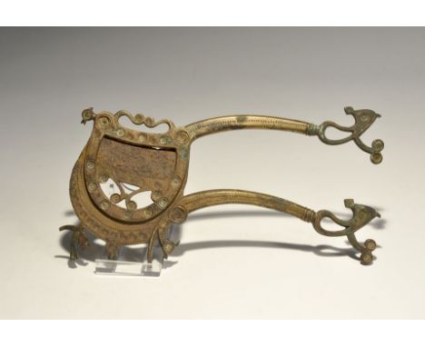 "19th century AD. A cutter comprising the bronze frame and handle with scroll finials, iron spring, bronze blade with integra