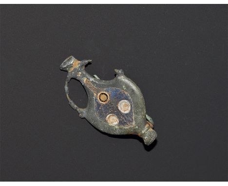 "1st-2nd century AD. A flat-section bronze plate brooch formed as an amphora with openwork handles, blue enamelled plaque to 