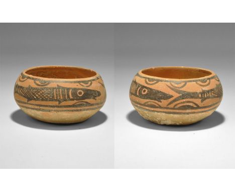 "3300-1700 BC. A squat terracotta cup with frieze of two fish with swags. 75 grams, 78mm (3"). See Satyawadi, S. Proto-Histor