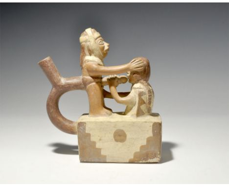 "20th century AD. A ceramic stirrup vessel formed as a female clutching the phallus of a standing male, on a rectangular base
