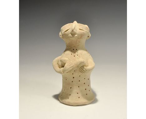 "20th century AD. A bell-shaped ceramic figurine with globular head; applied arms supporting the breasts, applied facial deta