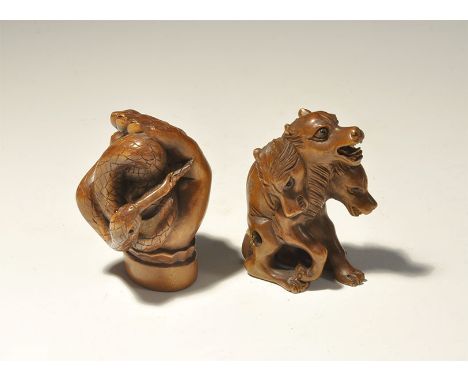 "Early 20th century AD. A pair of carved boxwood (?) netsuke figures comprising: a three-headed wolf with inset cabochon eyes