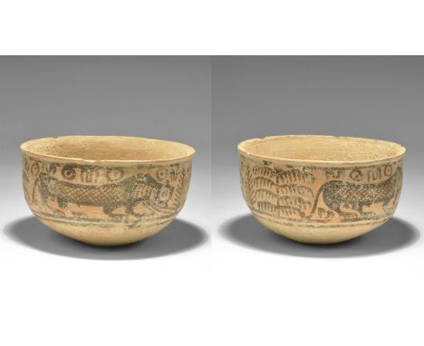 "3300-1700 BC. A hemispherical terracotta cup with advancing lions amid fronds, symbols above. 135 grams, 10cm (4"). See Saty