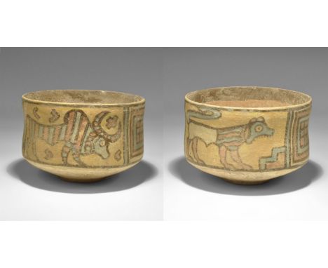"3300-1700 BC. A terracotta cup with painted polychrome geometric panels, advancing griffin and lion. 183 grams, 10cm (4"). S