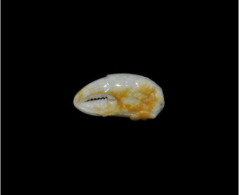 "20th century AD. A carved jade pendant of a crab's claw with low-relief lingzhi motif, crab and string of coins. 30 grams, 5