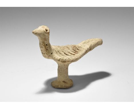 ". An undated archaistic hand-modelled terracotta figure of a bird with discoid base and column in 2nd millennium BC style, l
