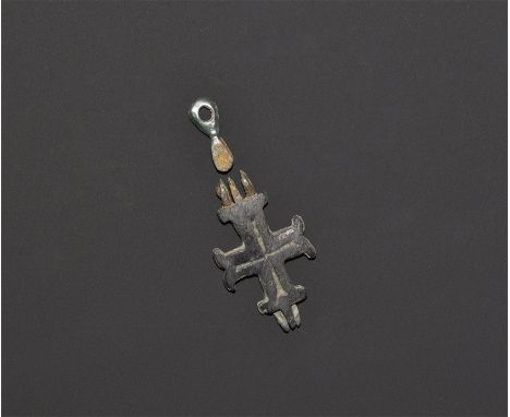 "9th-12th century AD. A cast two-part moline cross reliquary with suspension loop and simple line decoration on both sides, E