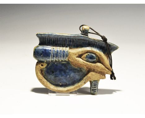 "20th century AD. A glazed ceramic pendant of the Eye of Horus with suspension loop. 234 grams, 12cm (4 3/4"). Property of a 