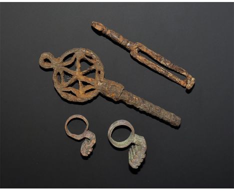 "1st-3rd century AD. A mixed group of keys comprising: two bronze with carinated ring and prongs on a canted block; one iron 