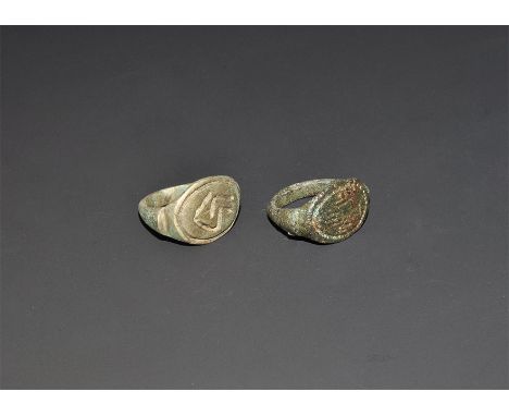 "1st-3rd century AD. A group of two bronze keeled finger rings comprising: one with D-section hoop, discoid bezel with incise