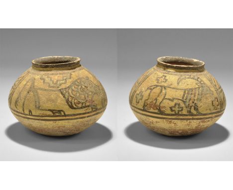 "3300-1700 BC. A squat terracotta jar with chamfered rim, polychrome geometric panels with crouching lion and advancing antel