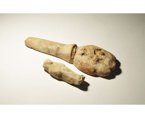 "20th century AD. A pair of ceramic items comprising: a shabti with tripartite wig; a hand and forearm with figure of Anubis.