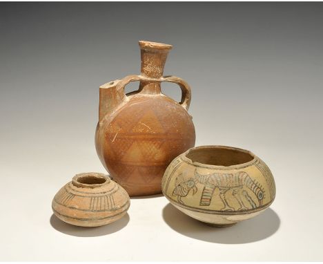 "3300-1700 BC. A mixed group of terracotta vessels comprising: a squat bowl with rounded underside, raised rim, painted segme