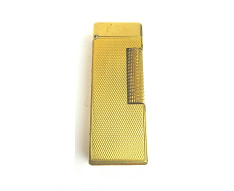 A gilt metal cased Dunhill rectangular gas lighter, with engine turned decoration.