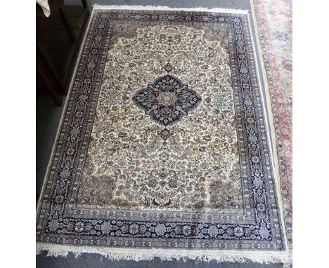 A small Pakistan carpet, the ivory field with a black medallion, grey spandrels, all with abundant floral sprays, a black flo