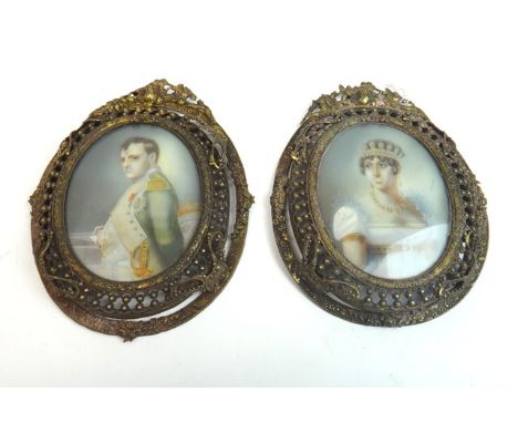 A pair of oval portrait miniatures of The Emperor Napoleon and Josephine Bonaparte displayed in oval pierced brass frames.