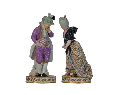 A pair of Meissen figures of a boy and girl, late 18th/early 19th century, both standing on a tile effect circular base, he s