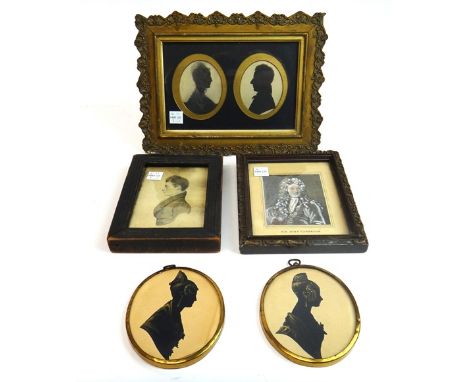 A pair of oval silhouette portraits of a lady and of a gentleman, displayed in a glazed moulded gilt frame, a pair of gilt hi