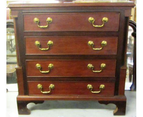 A 20th century miniature mahogany chest of four long graduated drawers on bracket feet, 59cm wide.