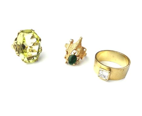 A 9ct gold and synthetic yellow gem set large dress ring, a 9ct gold and colourless gem set solitaire band ring and a gold, j