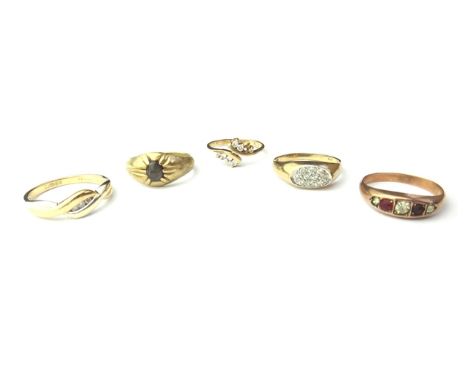 A gold and diamond set three stone ring, in a twistover design, detailed 9 K, a 9ct gold and colourless gem set ring, in a tw