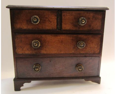 A 19th century miniature mahogany chest of two short and two long graduated drawers, on bracket feet, 30cm wide. 