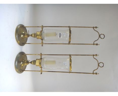 A pair of gilt metal hurricane lamps with Adams urn finials (55cm high), a set of three Victorian style brass fire tools and 