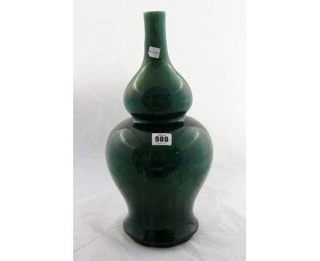 A Chinese green crackle-glazed double gourd vase, 18th century or later, the bright green emerald green glaze thinning to a l