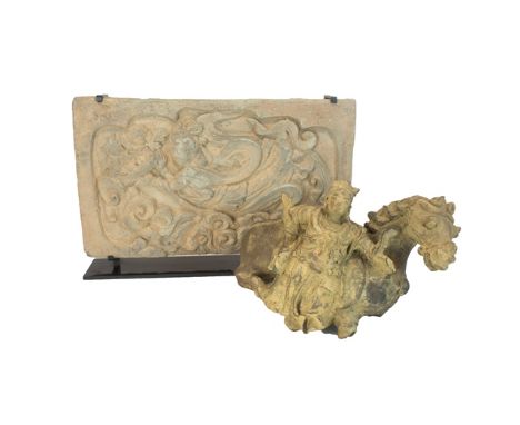 A Chinese rectangular tile, possibly Song/Yuan dynasty, depicting an aspara flying above clouds holding a basket of flowers, 