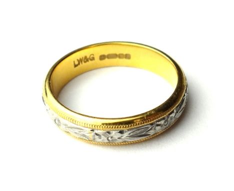 A 22ct yellow and white gold wedding ring, the central band, with floral engraved decoration between beaded edges, ring size 