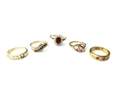 A 9ct gold, diamond and ruby set ring, mounted with four pairs of circular cut diamonds and with three circular cut rubies, a