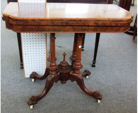 A Victorian figured walnut card table on four turned and downswept supports, 90cm wide. 