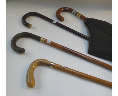 A Victorian walking cane with shagreen handle and gold collar, a similar walking cane with horn handle, a walking stick with 
