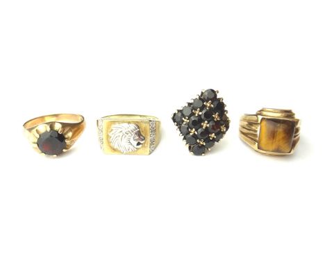 A 9ct gold and diamond set signet style ring, with a lion's head motif, a 9ct gold and garnet set single stone ring, a gold a