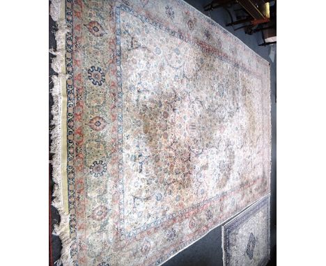 A Kerman carpet, Persian, the ivory field with an all over floral design of sprays and leaves, a complementary rosette and vi