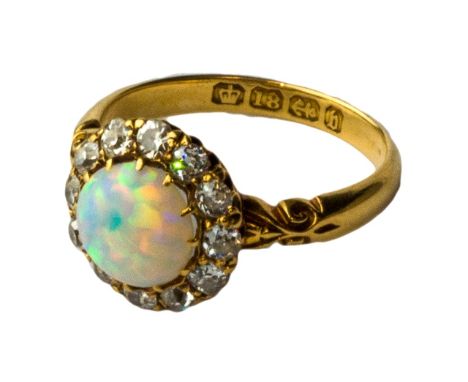 A Victorian 18ct gold, opal and diamond set cluster ring, claw set with a circular opal at the centre, within a surround of c