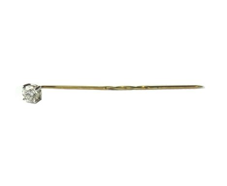 A gold and diamond set single stone stick pin, claw set with a circular cut diamond.