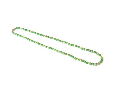 A single row necklace of spherical jade beads, with decorated divisions at intervals, on a diamond set navette shaped clasp.